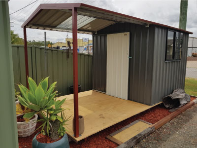 Garden Sheds - Grey Shed with Maroon roof in New Look Shed City display area