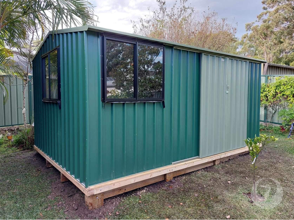Custom Colorbond Garden Sheds built and installed by New Look Shed City. Deluxe 4.61 x 3.10 gable shed in Cottage Green with two windows & double sliding doors in Pale Eucalypt.